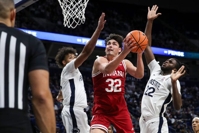 Hoosiers guard Trey Galloway (32) drives the ball to the basket as Penn State Nittany guard/forward Puff Johnson (4) and forward Qudus Wahab (22) defend.