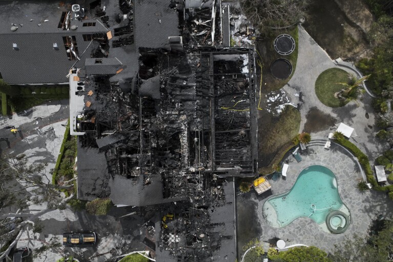 An aerial view shows a fire-damaged property, which appears to belong to Cara Delevingne, Friday, March 15, 2024, in the Studio City section of Los Angeles. (AP Photo/Jae C. Hong)