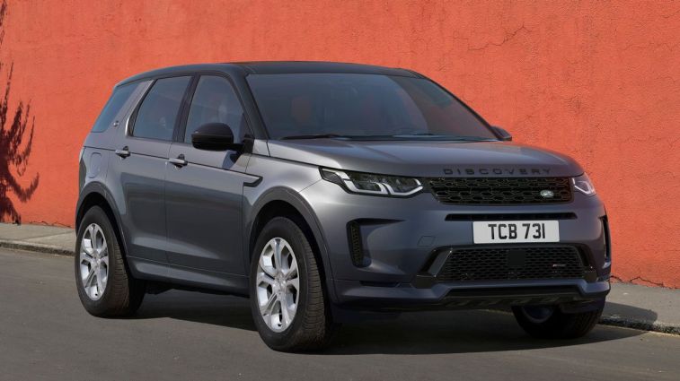 2024 Land Rover Discovery Sport parked next to an orange wall.