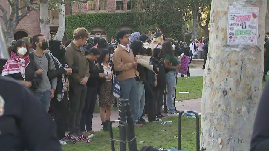 A circle of pro-Palestinian protestors standing with linked arms at USC on April 24, 2024. (KTLA)