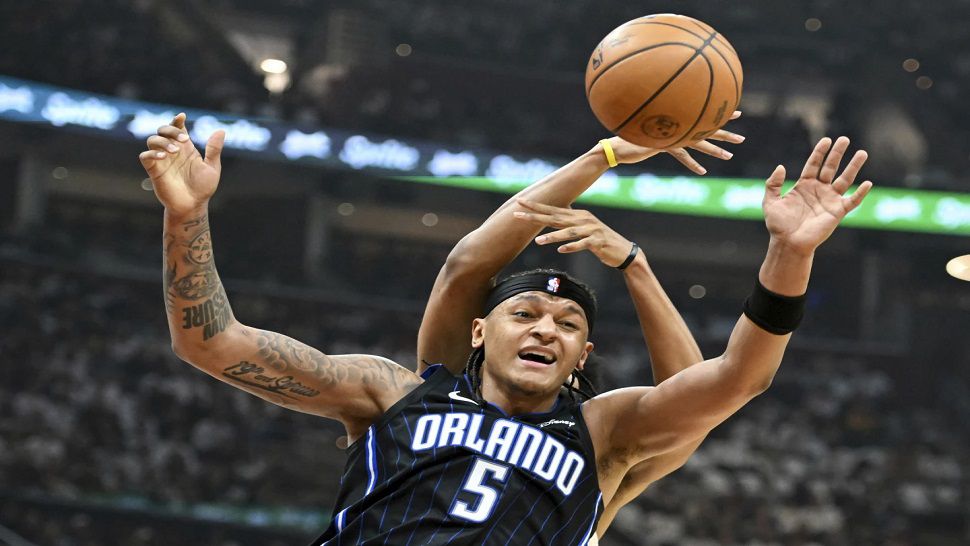 Orlando Magic's Paolo Banchero (5) fights for a rebound against Cleveland Cavaliers' Jarrett Allen during the first half in Game 1 of an NBA basketball first-round playoff series, Saturday, April 20, 2024, in Cleveland. (AP Photo/Nick Cammett)