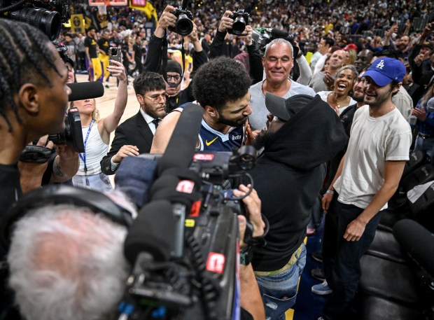 Jamal Murray (27) of the Denver Nuggets celebrates his second game-winning shot of the series with his father, Roger, after the fourth quarter of the Nuggets' 108-106 win over the Los Angeles Lakers at Ball Arena in Denver on Monday, April 29, 2024. The Nuggets eliminated the Lakers from the playoffs for the second straight year by way of a 4-1 series victory. (Photo by AAron Ontiveroz/The Denver Post)