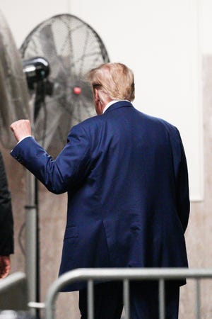 Former President Donald Trump walks at Manhattan Supreme Court amid his hush money trial, in New York on May 7, 2024.