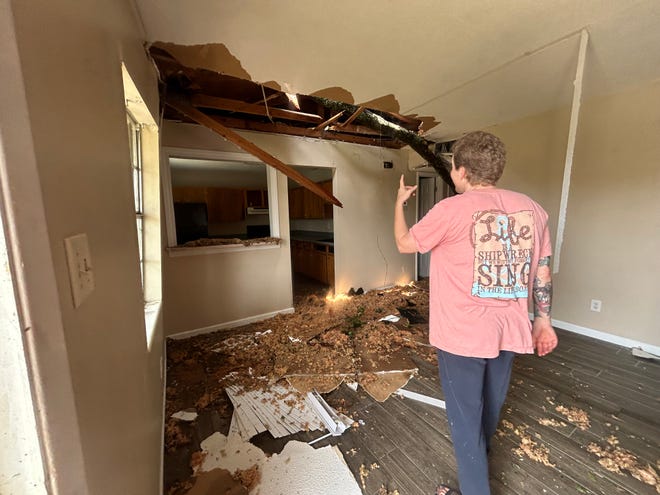 Suzanne Stafford showing the damage to the vacant unit on the other side of her triplex from Tallahassee's May 10, 2024, storm.