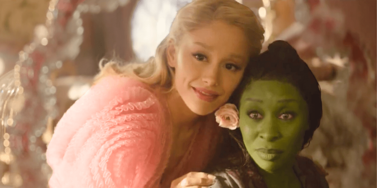 Glinda and Elphaba looking in a mirror together