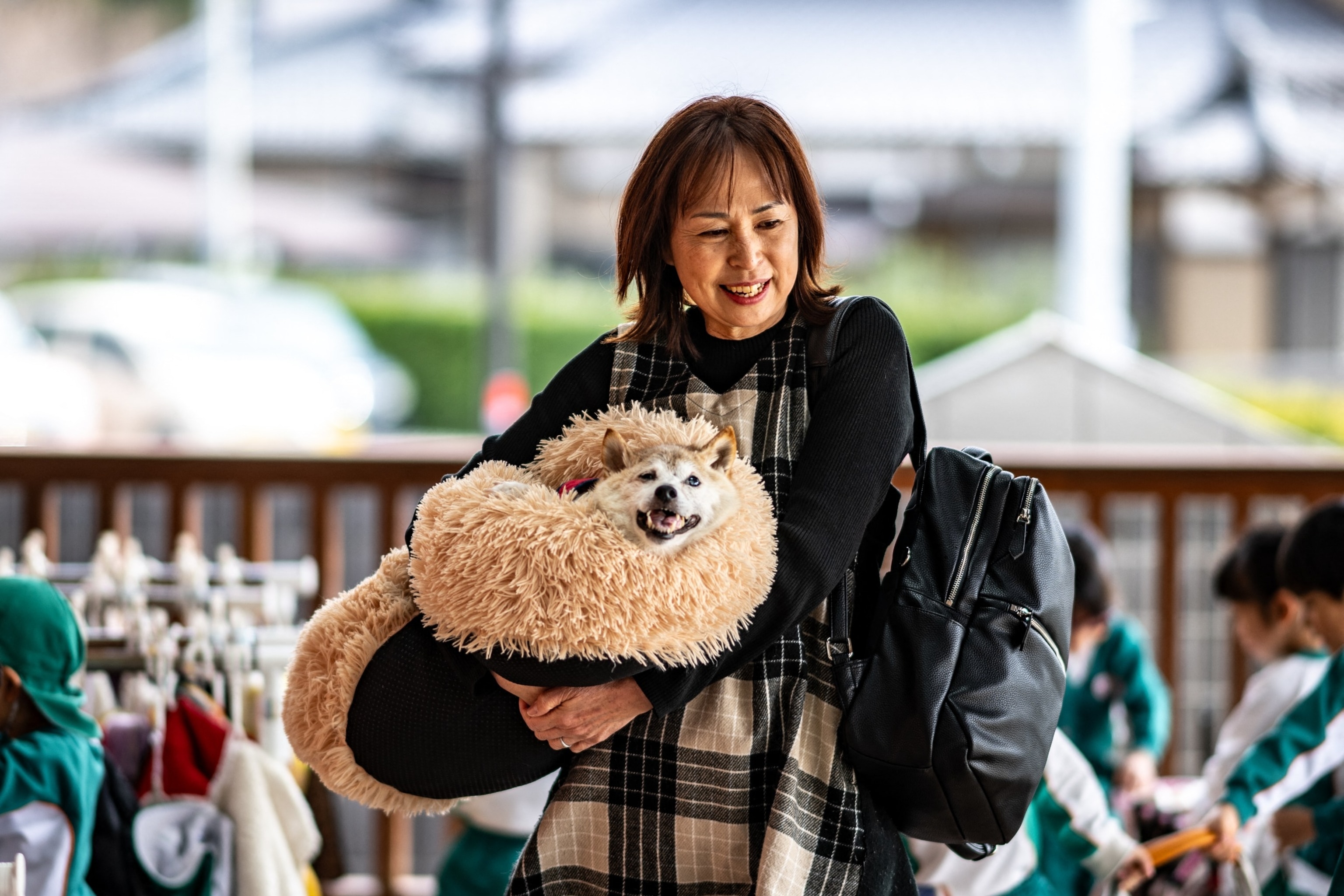 PHOTO: This picture taken on March 19, 2024 shows Atsuko Sato with her Japanese shiba inu dog Kabosu, best known as the logo of cryptocurrency Dogecoin, playing with students at a kindergarten in Narita, Chiba prefecture, east of Tokyo. 