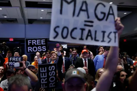 Getty Images Libertarian delegates hold up signs protesting Donald Trump