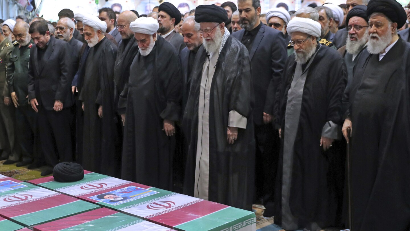 Iran’s supreme leader prays at president's funeral service