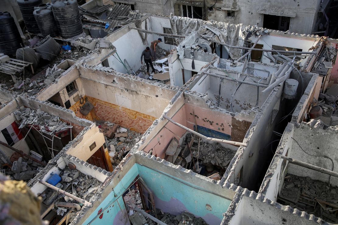 Palestinians inspect a house damaged in an Israeli strike in Rafah, in the southern Gaza Strip, on Tuesday.