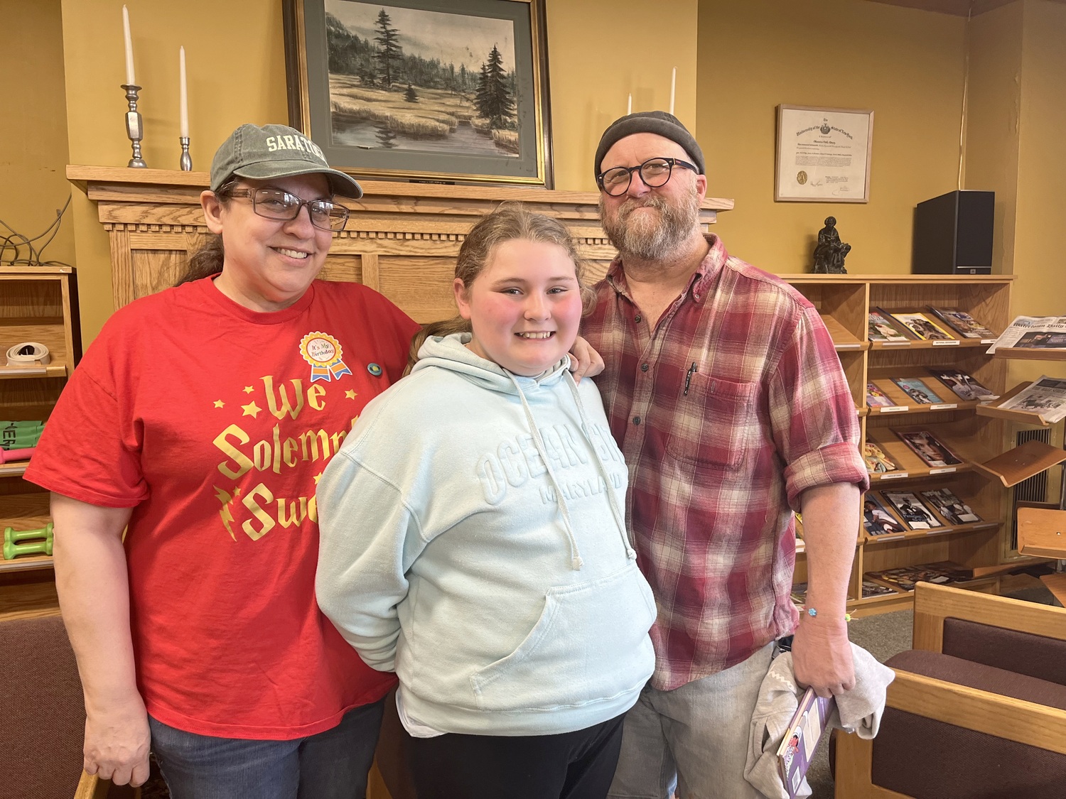 McKenna and her parents at the Massena Public Library. Photo: Monica Sandreczki