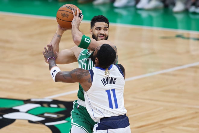 Jayson Tatum under pressure from Kyrie Irving.