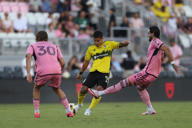 Jun 19, 2024; Fort Lauderdale, Florida, USA; Columbus Crew forward Cucho Hernandez (9) kicks the ball past Inter Miami CF forward Leo Campana (8) game at Chase Stadium. Mandatory Credit: Nathan Ray Seebeck-USA TODAY Sports