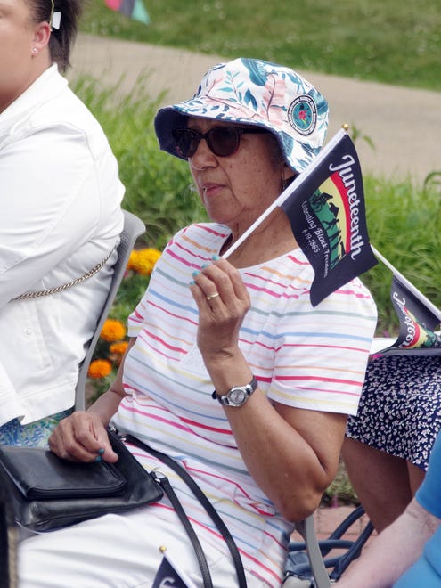 Beryl Domingo of Bridgewater waves her Juneteenth flag during comments made by Jenise Campbell-Means just prior to the raising of the Juneteenth flag in downtown Bridgewater on Monday, June 17, 2024.