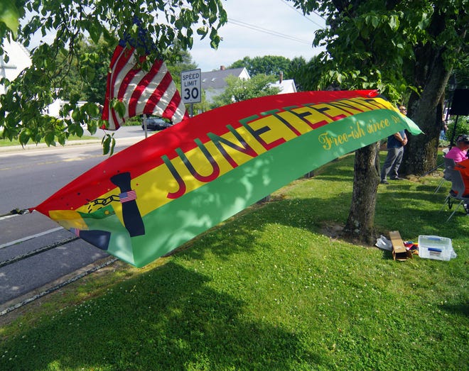 The Juneteenth flag flies with the American flag at the Juneteenth flag raising ceremony in downtown Bridgewater on Monday, June 17, 2024.