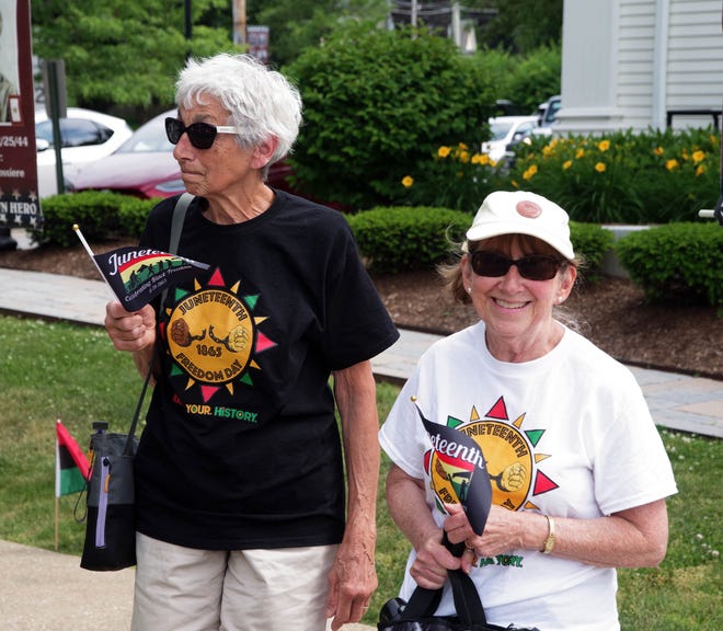 Debbie Baumgarten and Janet Dye, both of Bridgewater, take in the Juneteenth flag raising ceremony in downtown Bridgewater on Monday, June 17, 2024.