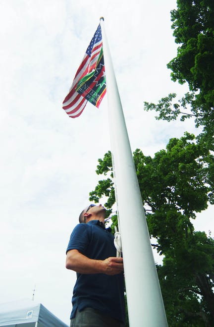 Chris Hartman, facilities manager for the town of Bridgewater, raises the Juneteenth flag at town hall in downtown Bridgewater on Monday, June 17, 2024. The flag will fly until the end of June.