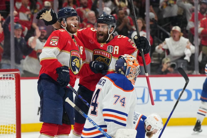 Jun 18, 2024; Sunrise, Florida, USA; Florida Panthers forward Matthew Tkachuk (19) celebrates scoring against Edmonton Oilers goaltender Skinner Stuart (74) with Florida Panthers defenseman Aaron Ekblad (5) during the second period in game five of the 2024 Stanley Cup Final at Amerant Bank Arena. Mandatory Credit: Jim Rassol-USA TODAY Sports