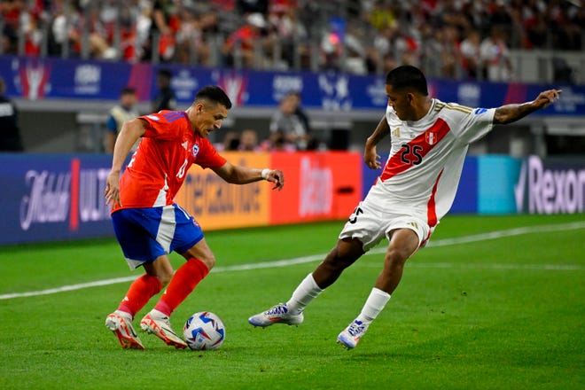 Jun 21, 2024; Arlington, TX, USA; Chile forward Alexis Sanchez (10) attempts to move the ball past Peru forward Joao Grimaldo (25) during the second half in a 2024 Copa America match at AT&T Stadium. Mandatory Credit: Jerome Miron-USA TODAY Sports