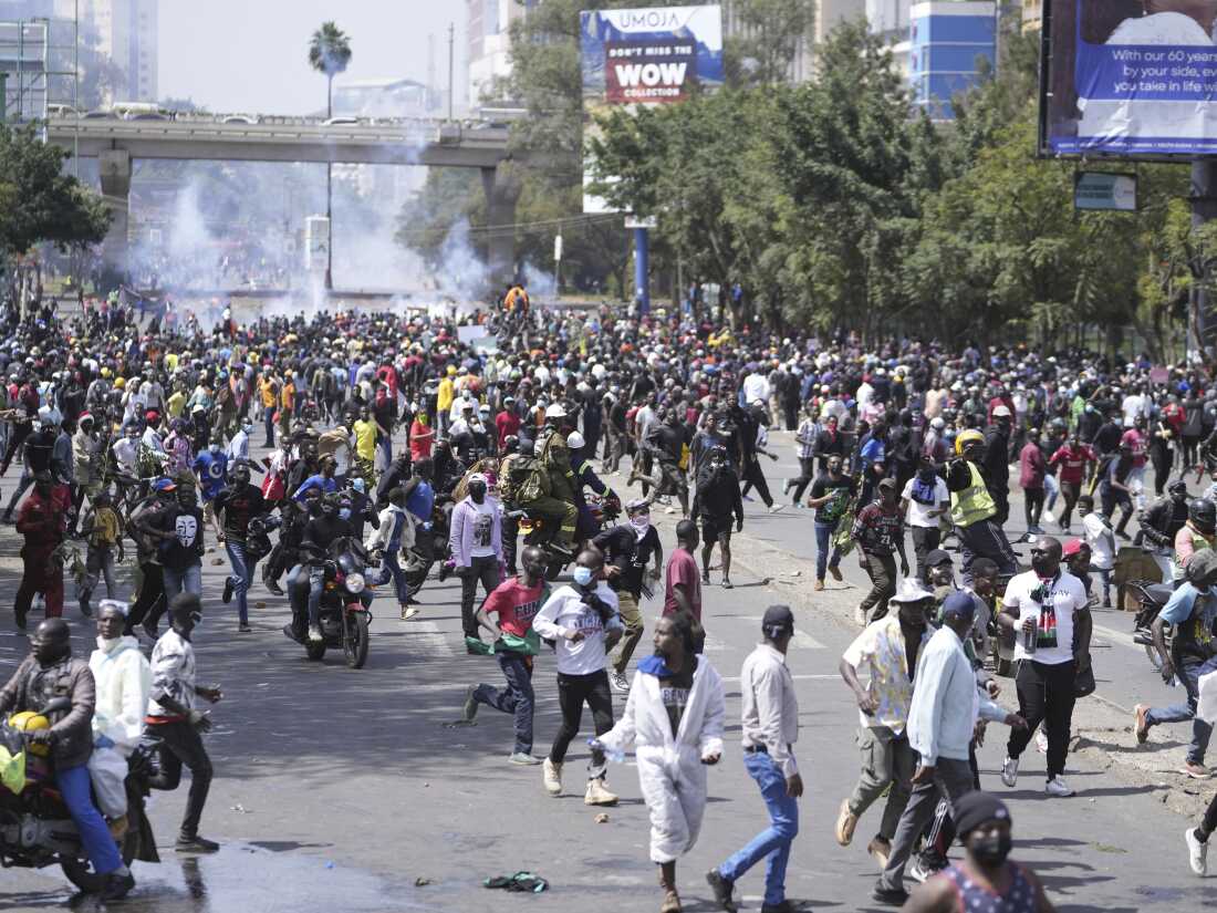 Demonstrators scatter during a protest over proposed tax hikes in a finance bill in downtown Nairobi, Kenya, on Tuesday.