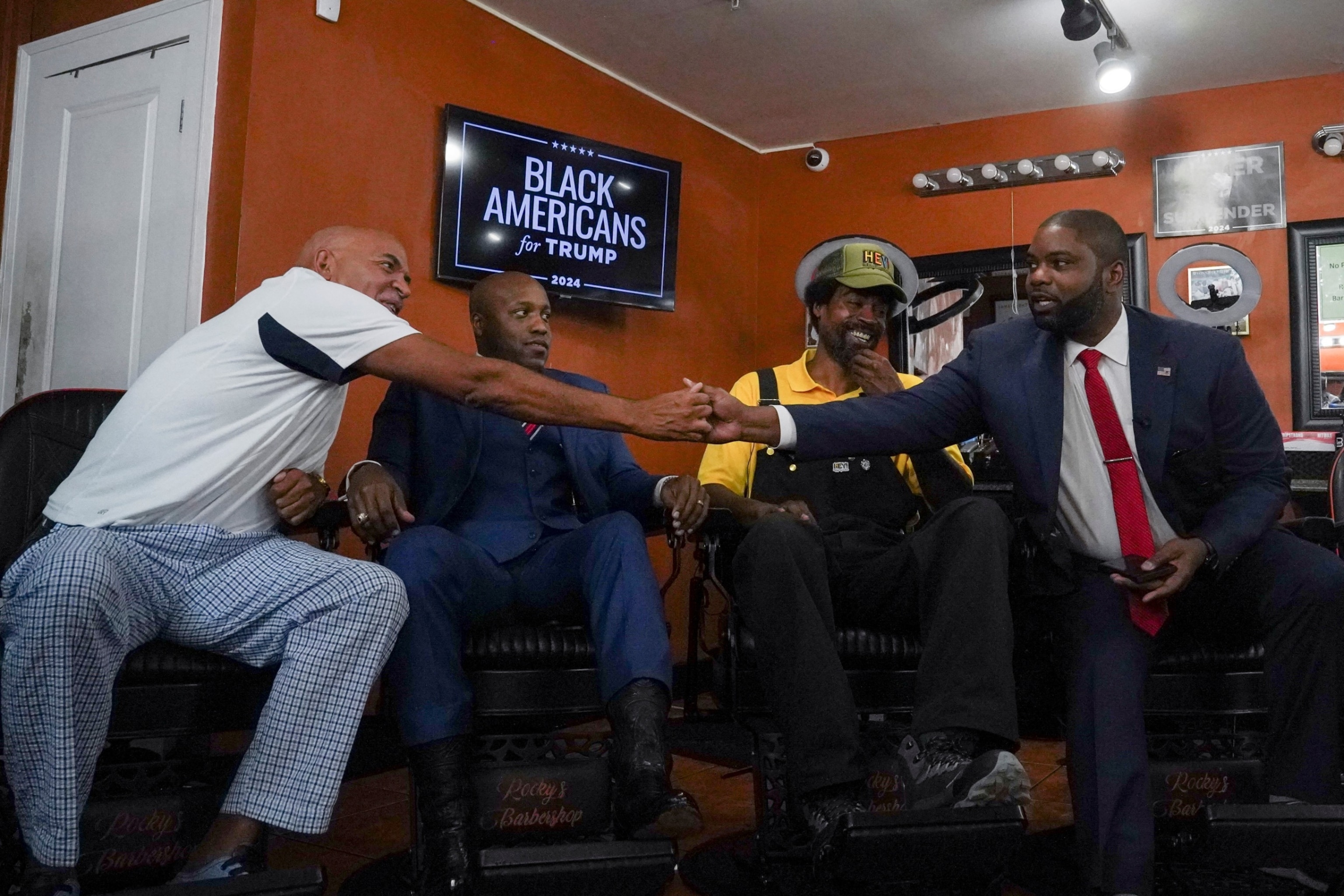 PHOTO: Radio host Wynter and Congressman Donalds shake hands at a round table discussion hosted by former President Trump during a campaign stop for a 