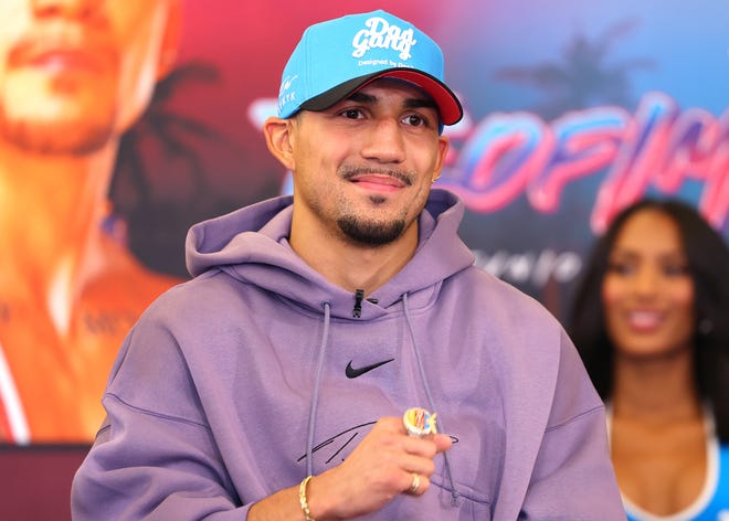 Teofimo Lopez smiles at a fight week press conference ahead of his June 29 junior welterweight title defense against Steve Claggett in the main event of Top Rank's card from Miami Beach.