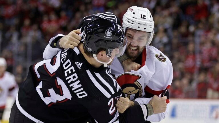 NEWARK, NEW JERSEY - MARCH 23: Mark Kastelic #12 of the Ottawa Senators fights Kurtis MacDermid #23 of the New Jersey Devils during the first period at the Prudential Center on March 23, 2024 in Newark, New Jersey.