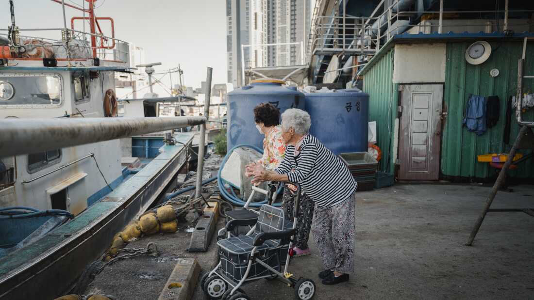 Abai Village residents Lee Choo-sum, left, and Lee Geum-soon, look out for free fish or seafood from fishing boats in Abai Village in Sokcho, South Korea on Friday, September 8, 2023. Both women left North Korea when the war broke out and have lived in Abai Village for the past 70 years, never going back home due to the closed border.