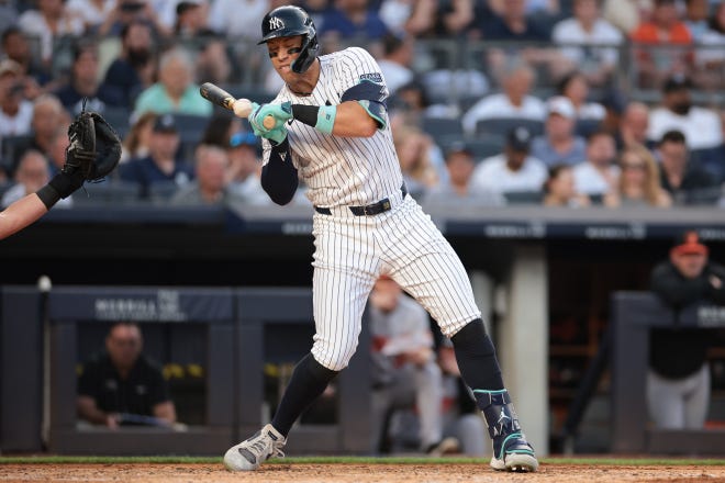 New York Yankees center fielder Aaron Judge (99) is hit by a pitch during the third inning against the Baltimore Orioles at Yankee Stadium.