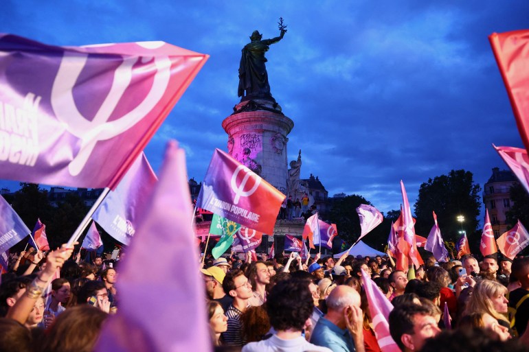 A rally in support of the left wing New Popular Front - NFP and against the RN in Paris. People are waving NFP flags and banners