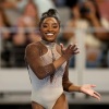 Simone Biles smiles during her floor exercise routine at the U.S. Gymnastics Championships on Sunday.