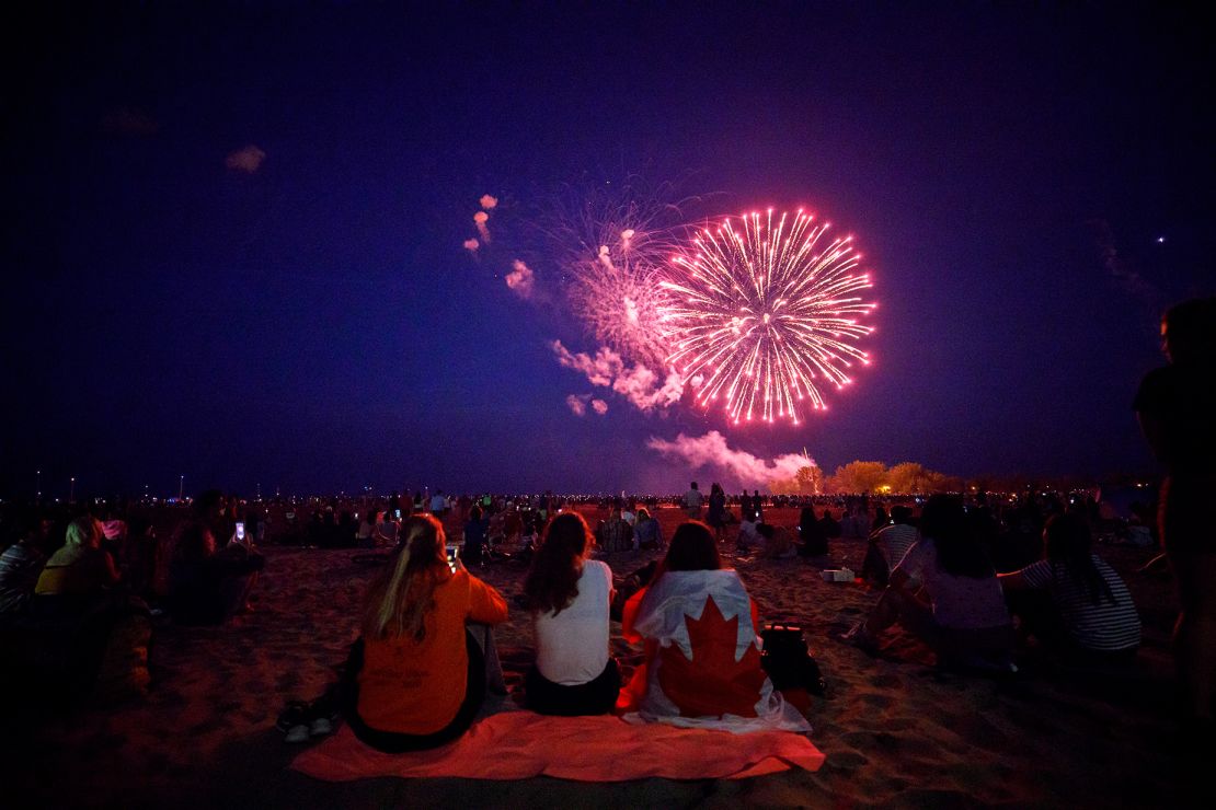 People watch fireworks over Ashbridges Bay during Canada Day festivities on July 1, 2019 in Toronto.