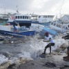 Fishermen pull a boat damaged by Hurricane Beryl back to the dock at the Bridgetown Fisheries in Barbados on Monday, July 1.