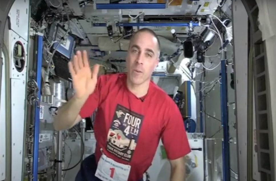 Expedition 36 astronaut Christopher J. Cassidy wears a T-shirt from the Four on the Fourth race in York, Maine