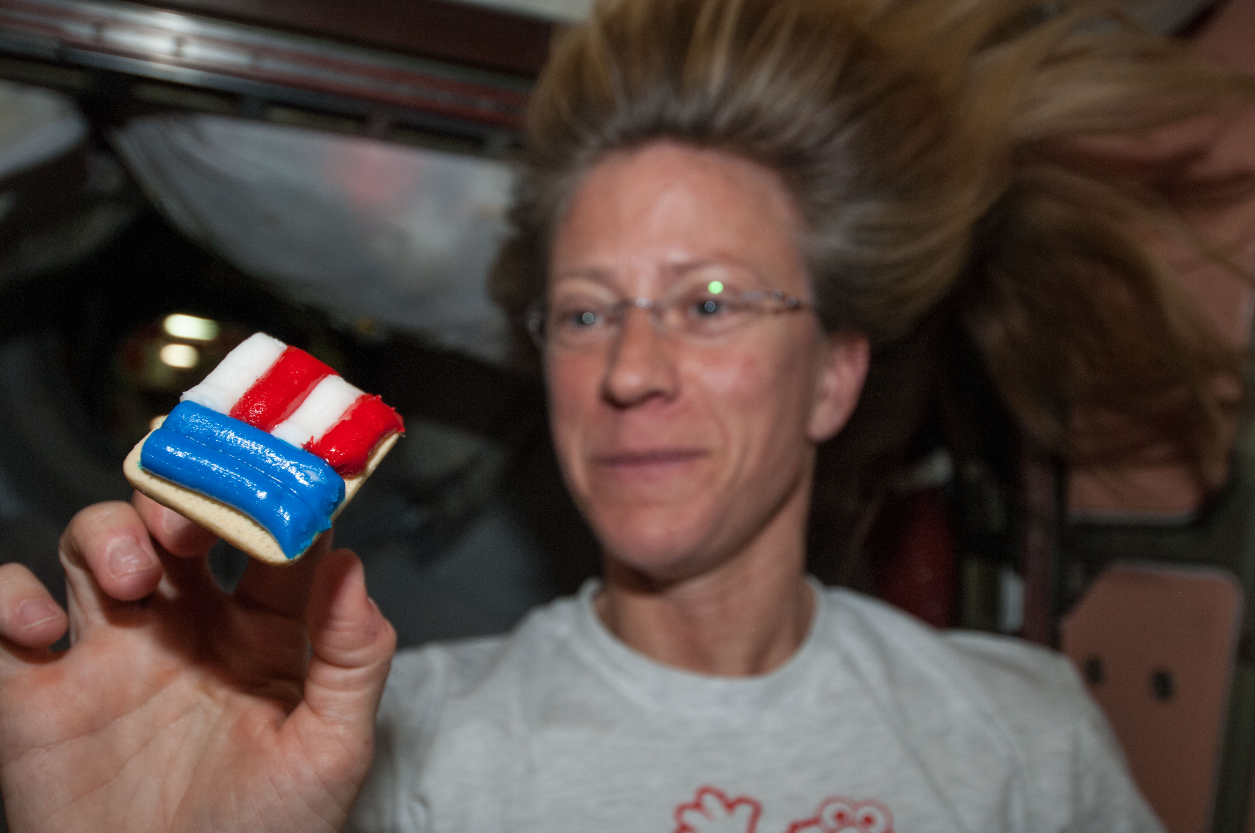 Expedition 36 astronaut Christopher J. Cassidy wears a T-shirt from the Four on the Fourth race in York, Maine