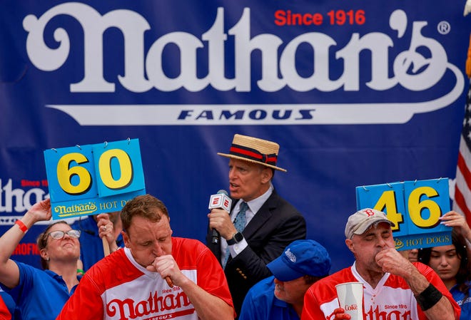 World Champion Joey Chestnut and Geoffrey Esper compete in 2023 Nathan's Famous Fourth of July International Hot Dog Eating Contest at Coney Island in New York City, U.S., July 4, 2023.