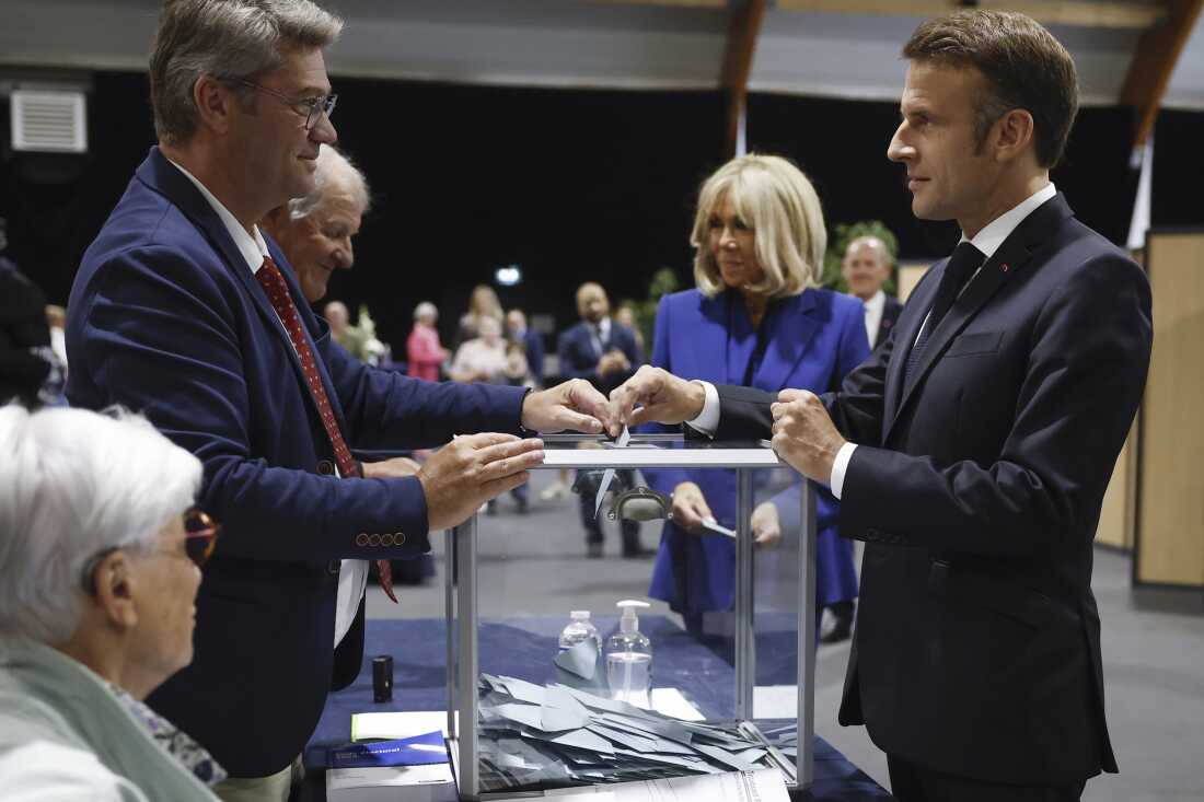 French President Emmanuel Macron, right, votes for the second round of the legislative elections in Le Touquet-Paris-Plage, northern France, on Sunday.