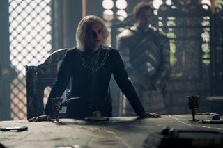 Tom Glynn-Carney as Aegon Targaryen, standing at the Small Council table, in 'House of the Dragon'