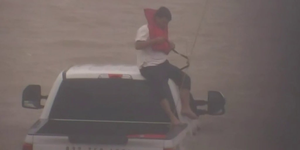 VIDEO: Man rescued after stranded on top of truck in Houston floodwaters