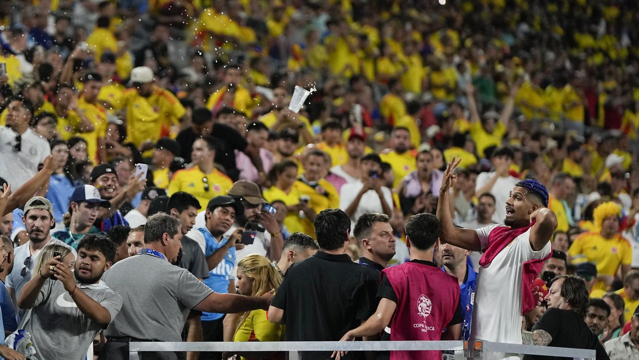 Uruguay's Ronald Araujo, right, argues with fans at the end of a Copa America semifinal soccer match against Colombia, Wednesday, July 10, 2024, in Charlotte, N.C. (AP Photo/Julia Nikhinson)