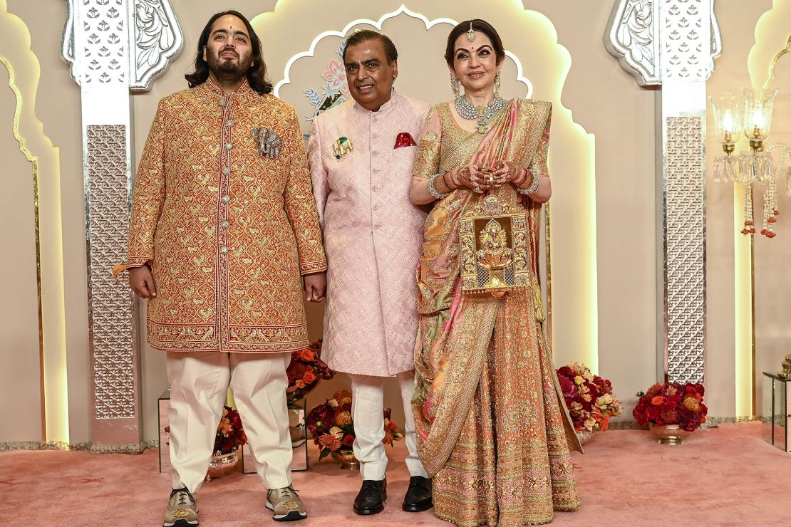 From left to right, Anant Ambani alongside his father Mukesh Ambani and mother Nita, whose dress took artisans 40 days to handcraft.