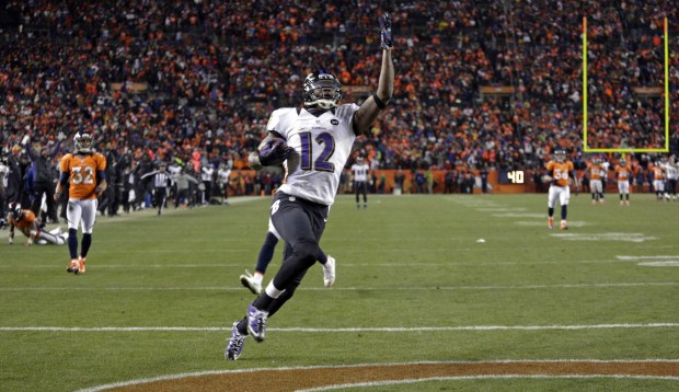 Ravens wide receiver Jacoby Jones celebrates as he crosses the...