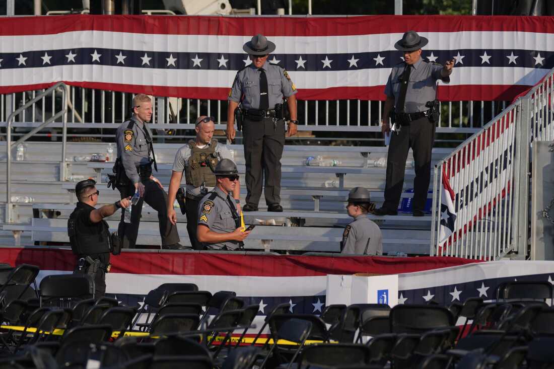 Law enforcement officers gather at the campaign rally site for Republican presidential candidate former President Donald Trump on Saturday, July 13, 2024, in Butler, Pa. Trump's campaign said in a statement that the former president was 