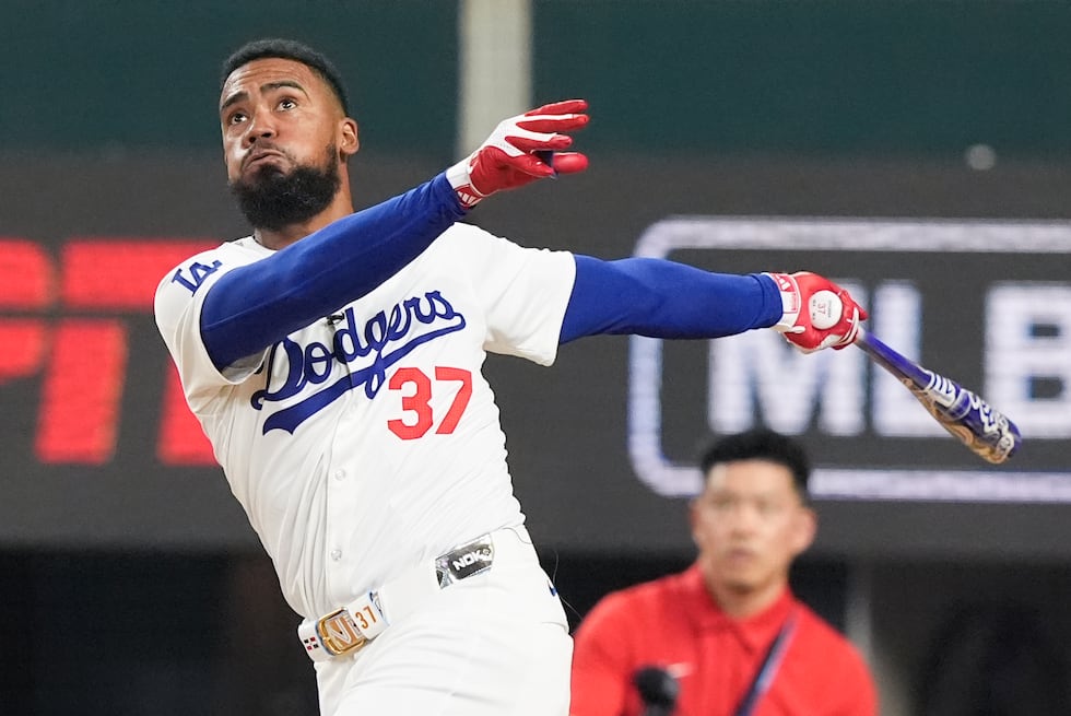 National League's Teoscar Hernandez, of the Los Angeles Dodgers, follows through during the...