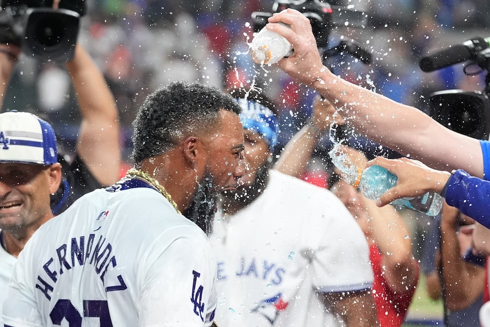 National League's Teoscar Hernández, of the Los Angeles Dodgers, celebrates after winning the...