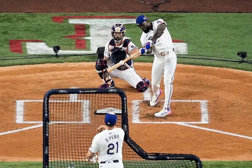 Adolis Garcia, of the Texas Rangers, hits a home run during the first round of the MLB...