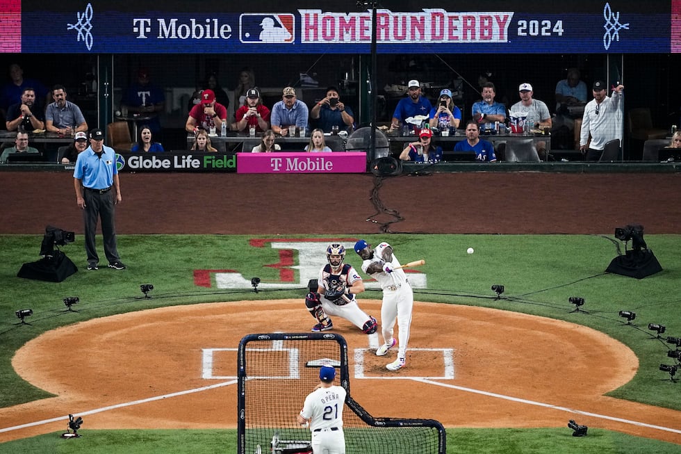 Adolis Garcia, of the Texas Rangers, hits a home run during the first round of the MLB...