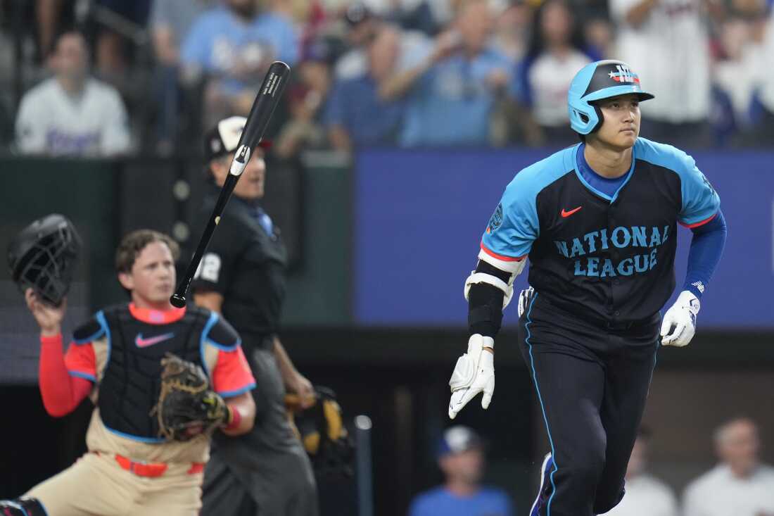 The National League's Shohei Ohtani of the Los Angeles Dodgers flips his bat as he hits a three-run home in the third inning during the MLB All-Star baseball game on Tuesday in Arlington, Texas.