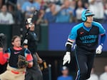 The National League's Shohei Ohtani of the Los Angeles Dodgers flips his bat as he hits a three-run home in the third inning during the MLB All-Star baseball game on Tuesday in Arlington, Texas.