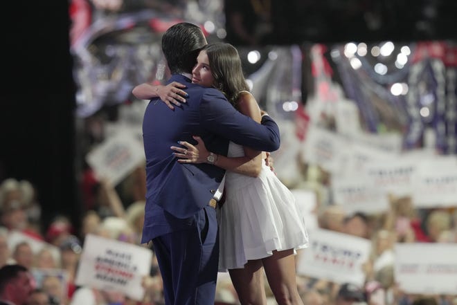 Kai Trump hugs her father Donald Trump Jr. during the third day of the Republican National Convention at Fiserv Forum. The third day of the RNC focused on foreign policy and threats.