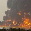 A handout picture obtained from Yemen's Huthi Ansarullah Media Center show a huge column of fire erupting following reported strikes by Israeli fighter jets in the Yemeni rebel-held port city of Hodeidah on Saturday.